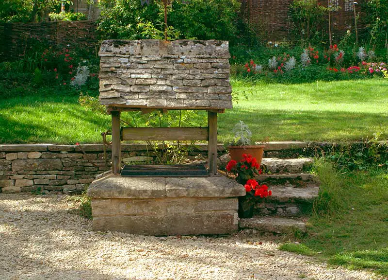 a garden well made of brick and wood