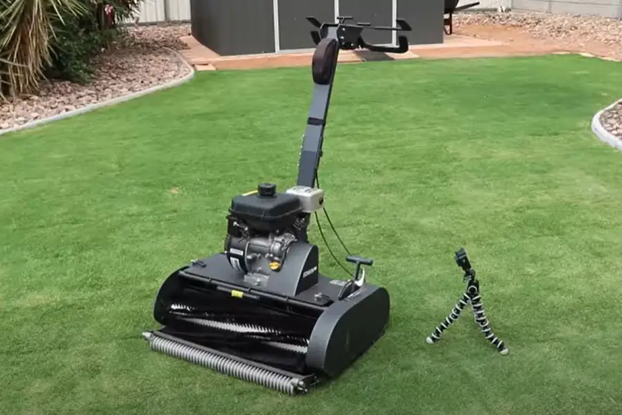 a cylinder lawn mower sat in the center of the garden