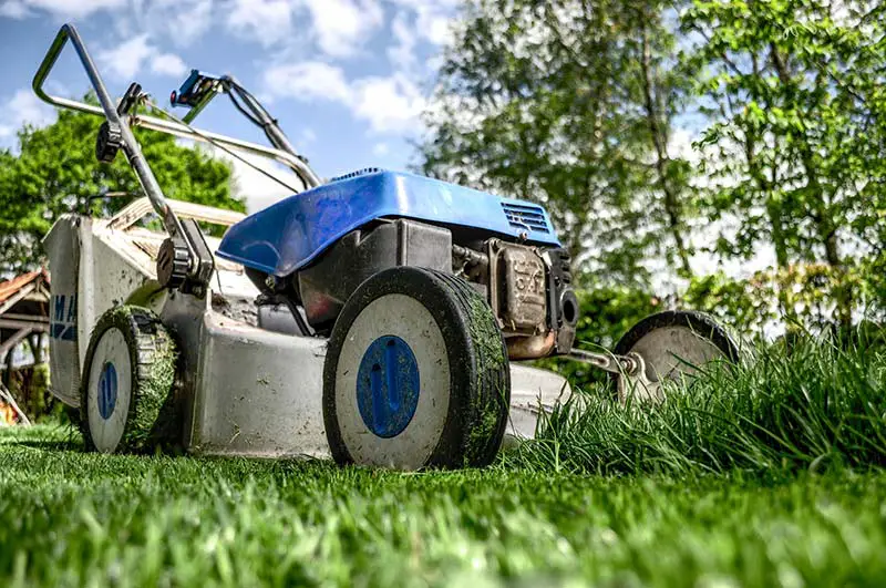 a lawn mower mowing a lawn