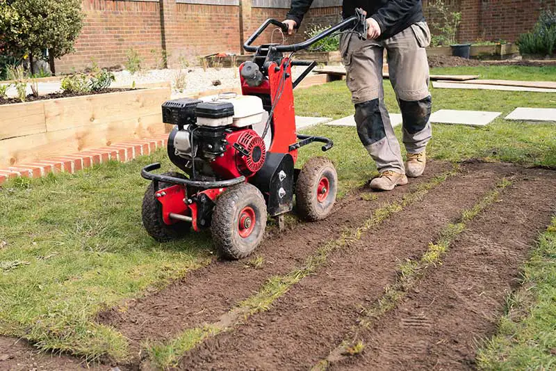 sod cutter cutting strips out of a lawn